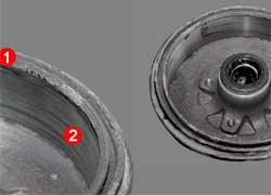 Барабан, изношенный не более допустимого, можно восстановить, сточив буртик (1) и выровняв канавки (2) на рабочей части.